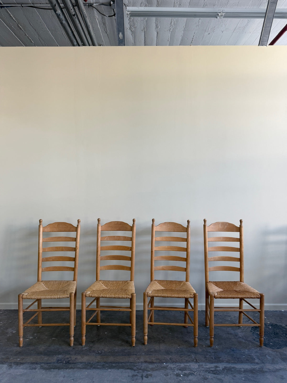 Beech ladder back rush seat dining chairs. Sold in pairs.