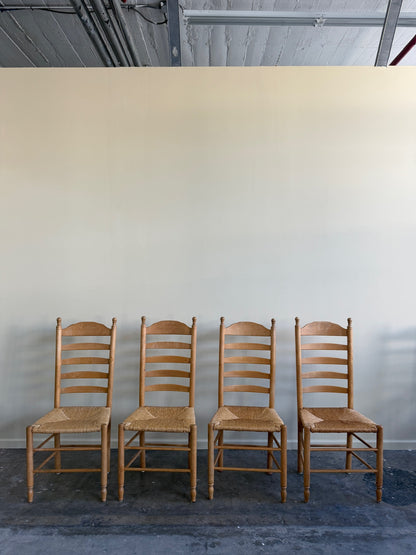Beech ladder back rush seat dining chairs. Sold in pairs.