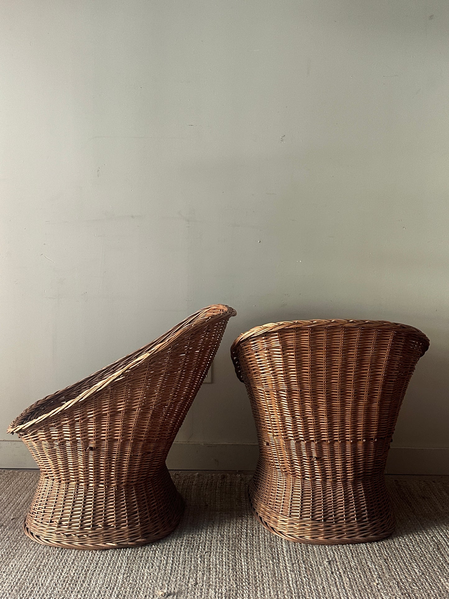 Wicker lounge chairs. Sold individually.