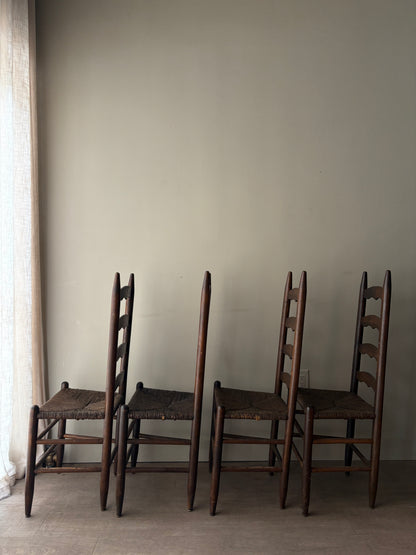Stained oak rush seat ladder back dining chairs. Sold in pairs.