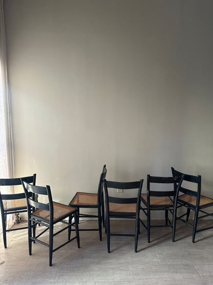 6 cane and black painted dining chairs. Sets of 2.