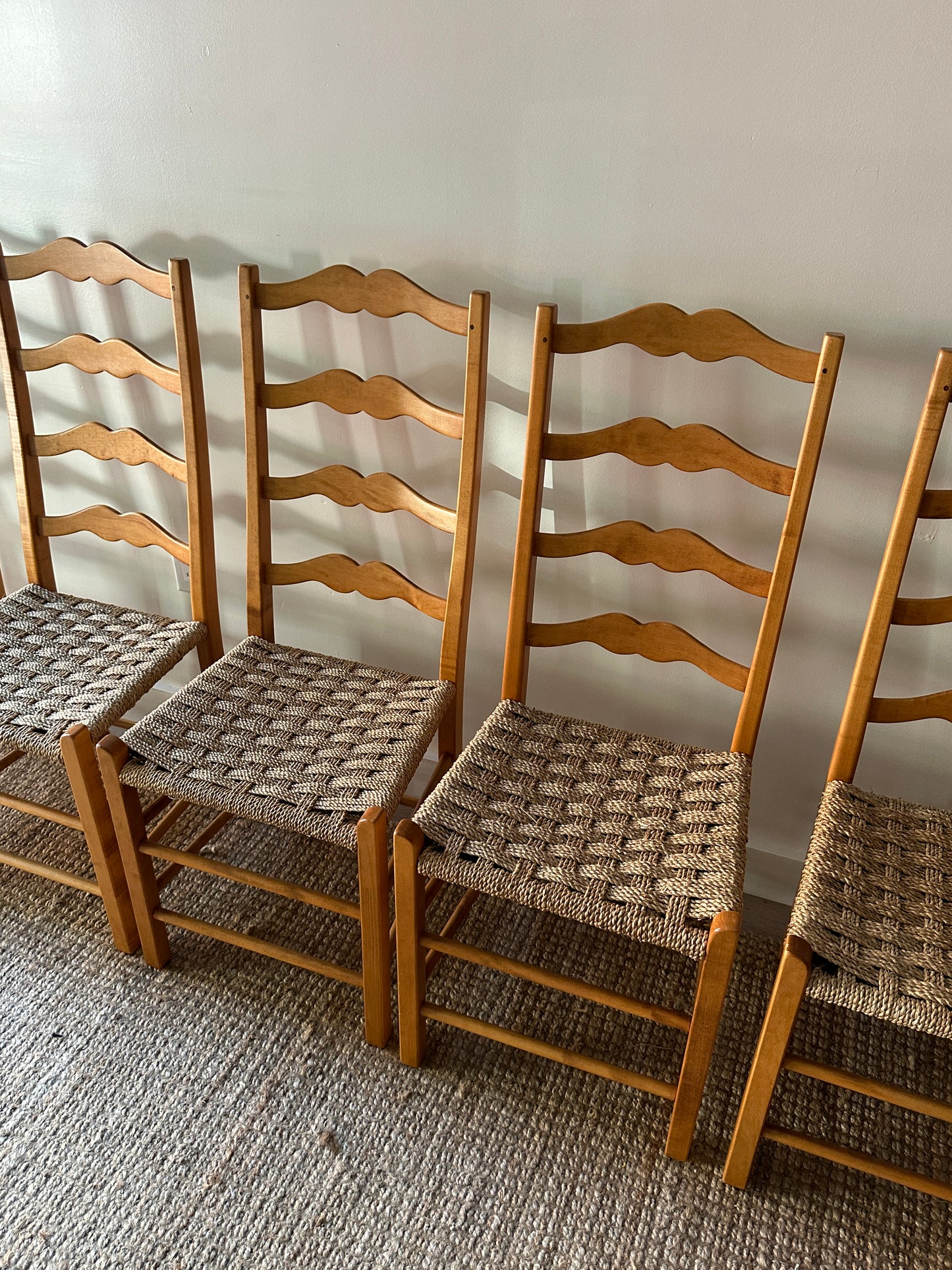 Ladder back chairs with woven seats. Sold in sets of 2.