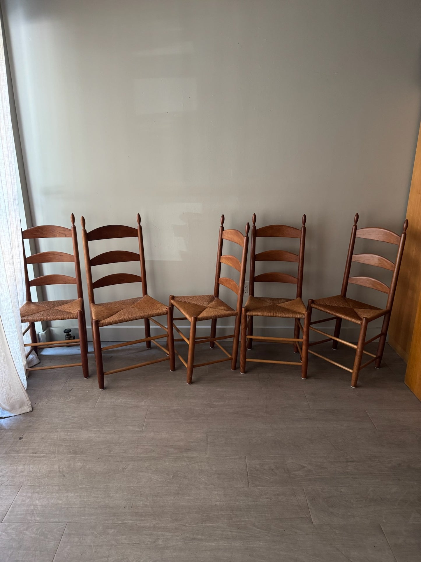 Cherry ladder back rush seat chairs. Sold individually.