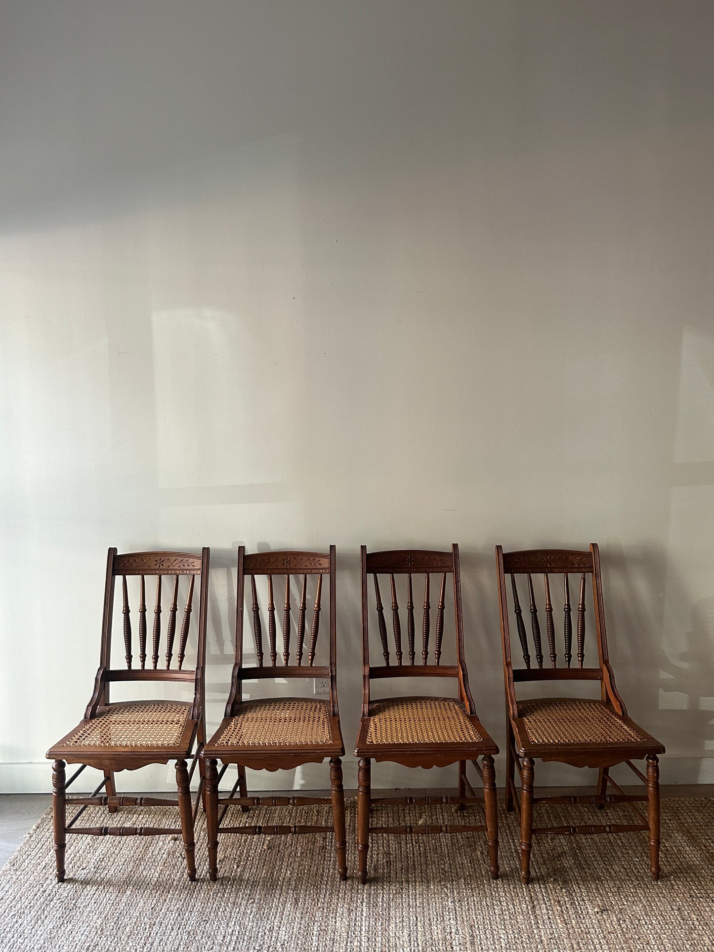 Carved cane chairs. Sold individually.