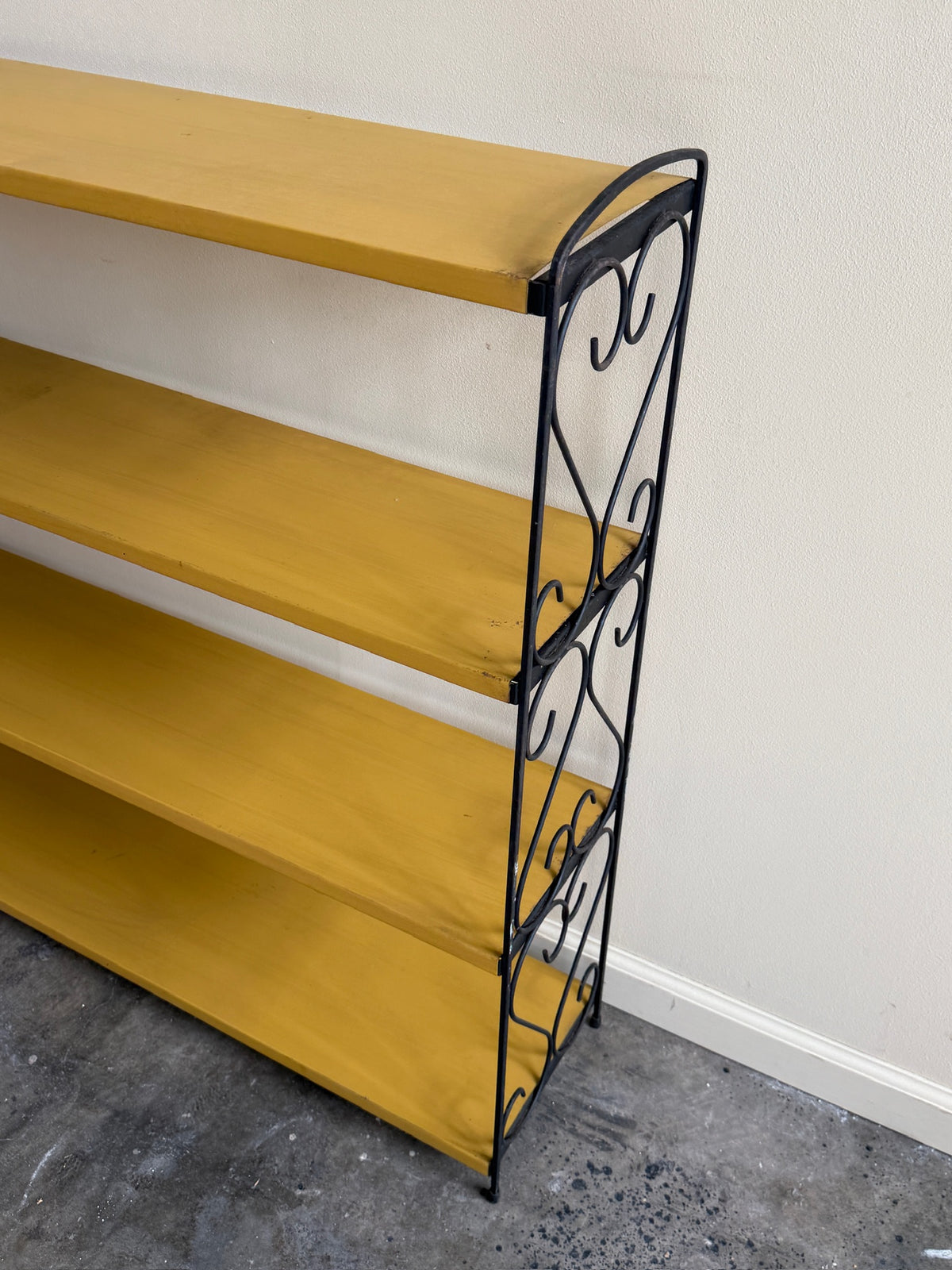 Yellow painted metal shelf