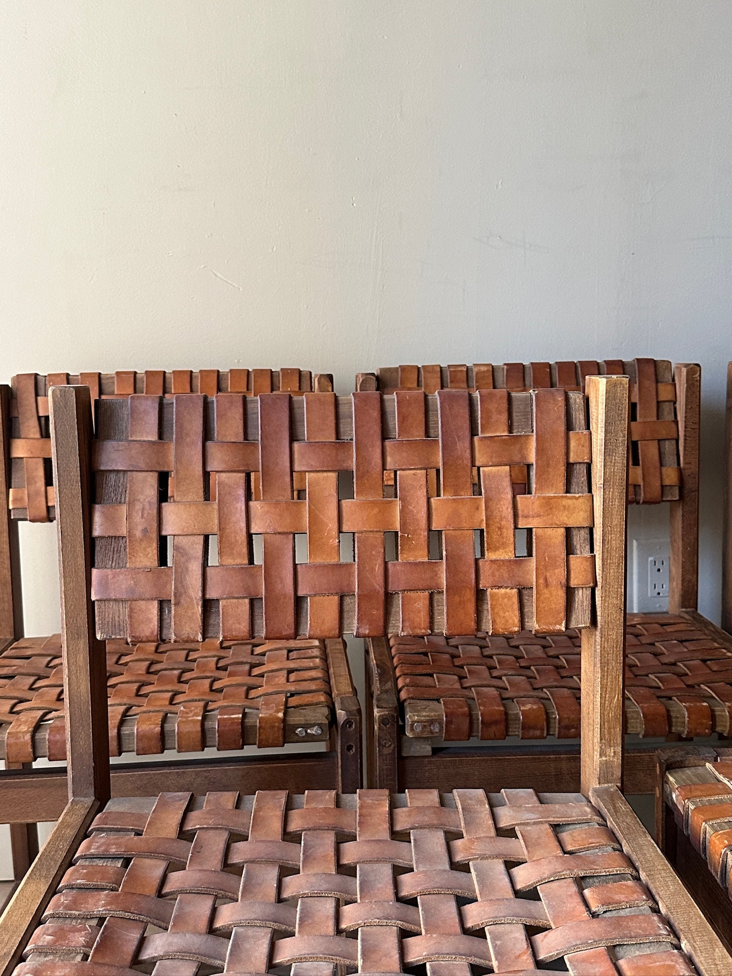 10 Jens Risom style woven leather dining chairs. Sold individually.