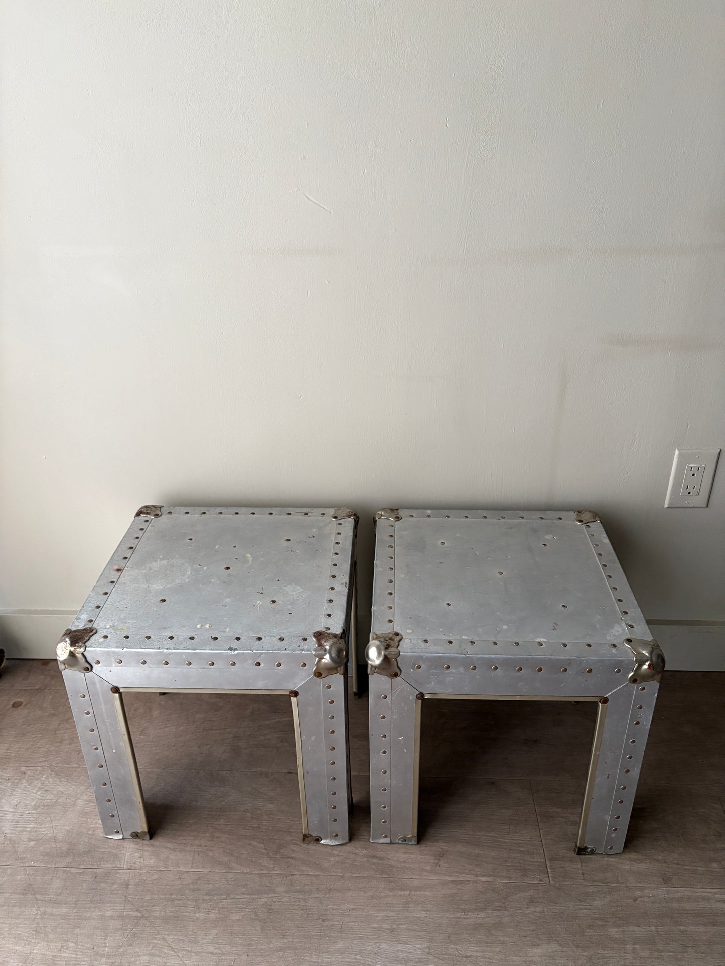 Riveted metal cocktail tables. Sold individually.