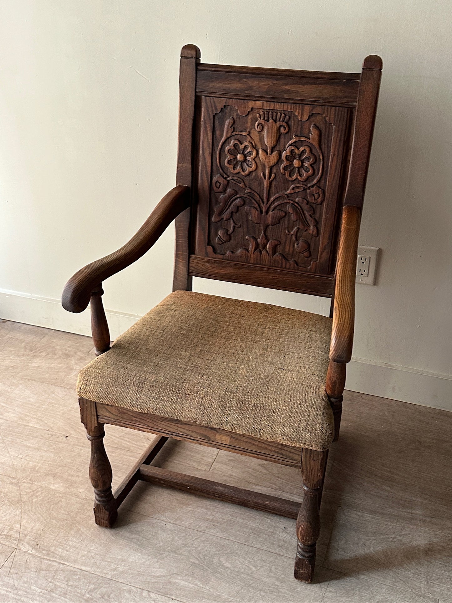Carved oak upholstered armchair
