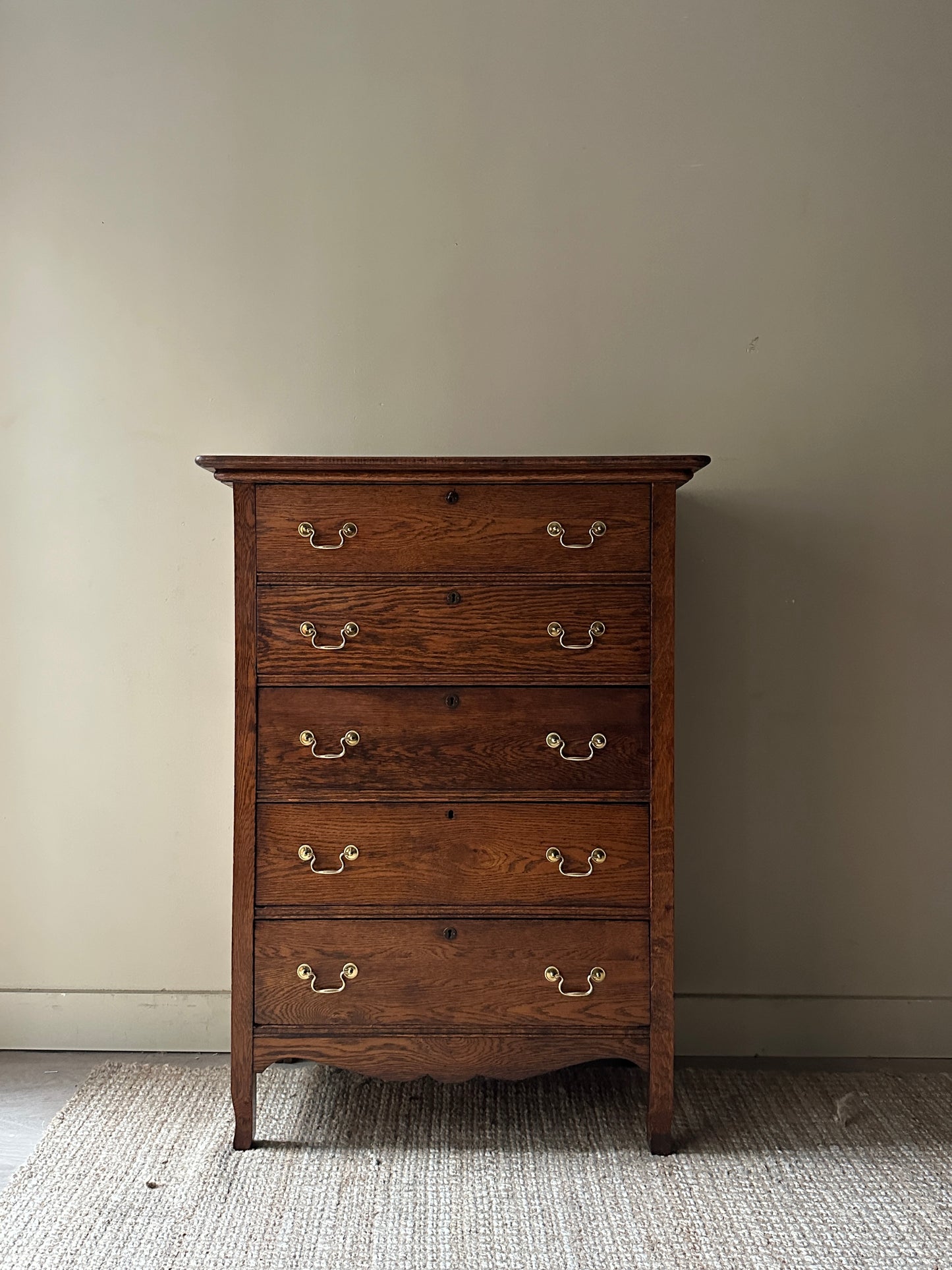 Oak tallboy with brass handles