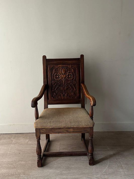 Carved oak upholstered armchair