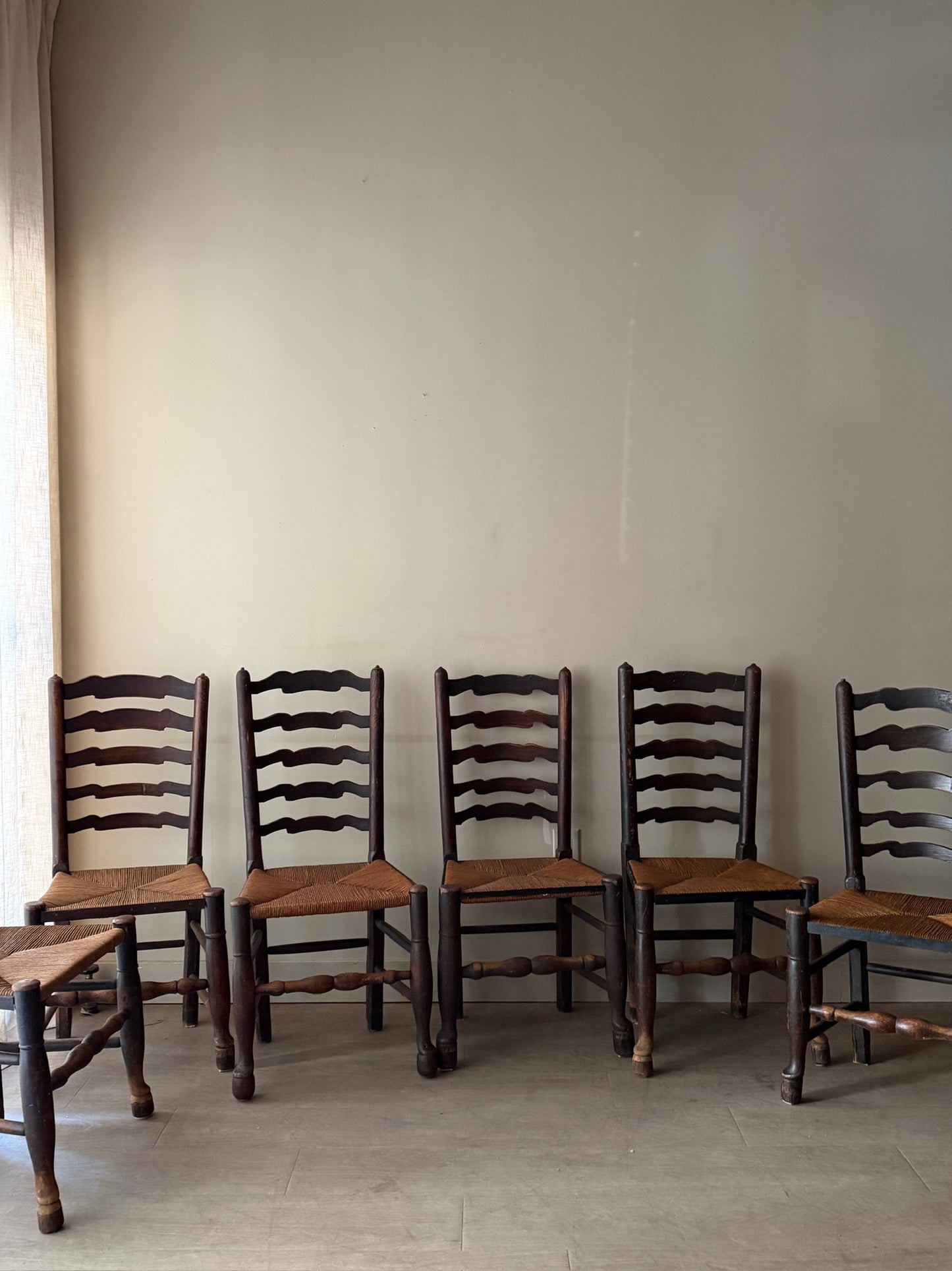 English provincial elmwood ladder back rush seat chairs. Sold in pairs.
