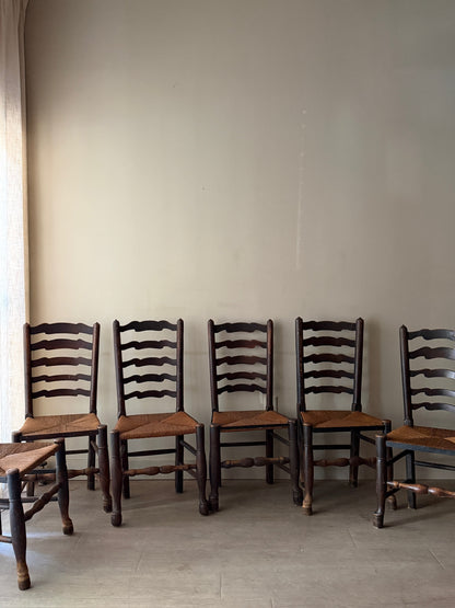 English provincial elmwood ladder back rush seat chairs. Sold in pairs.