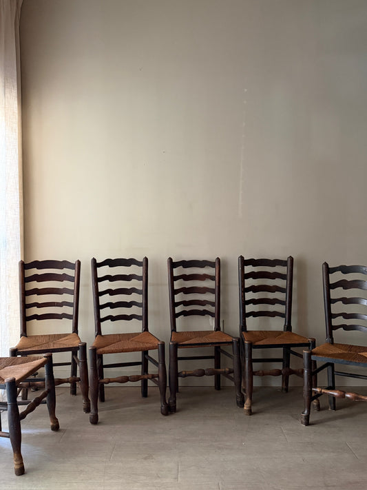 English provincial elmwood ladder back rush seat chairs. Sold in pairs.