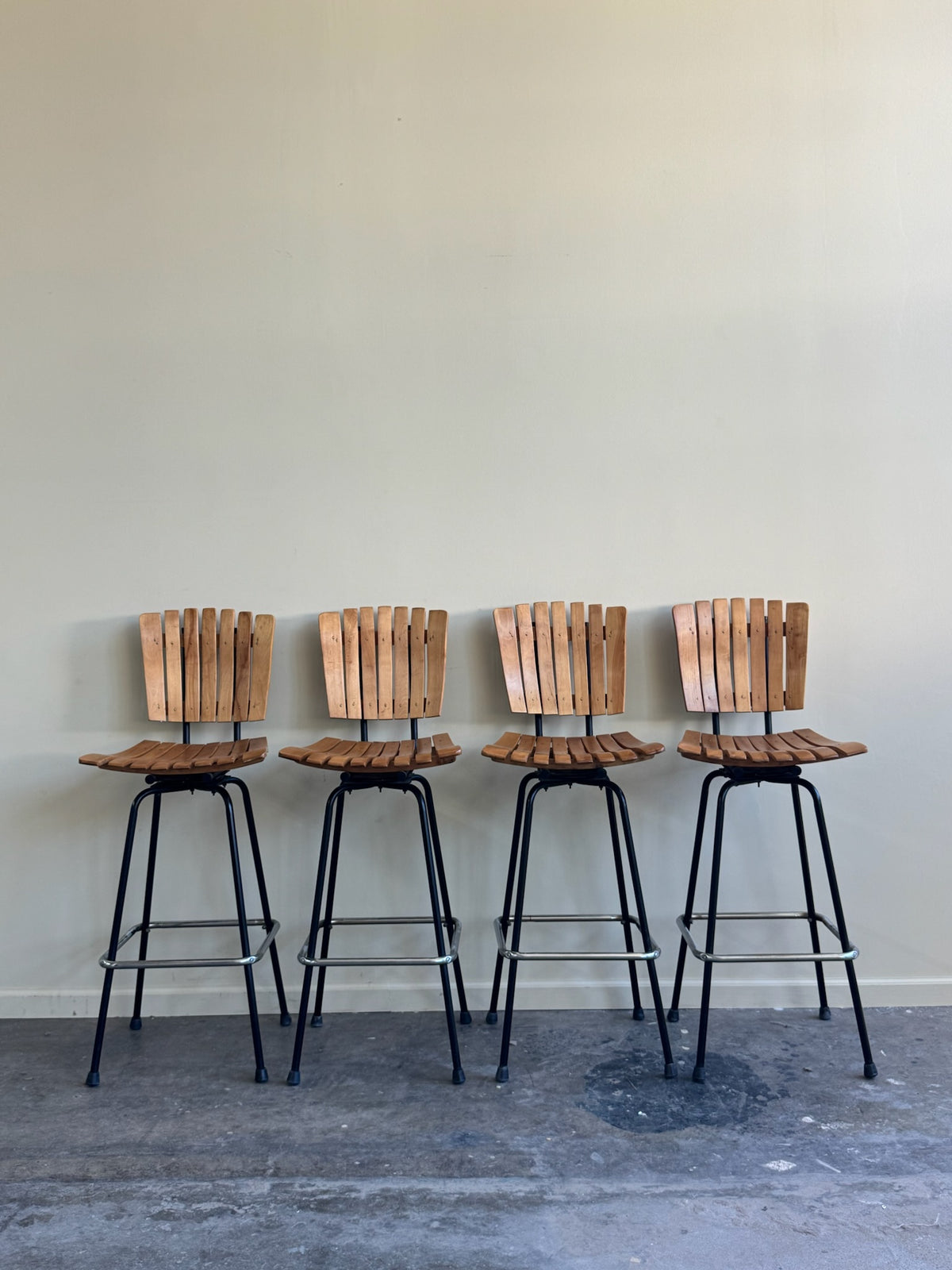 Slatted maple swivel bar stools. Sold in pairs.