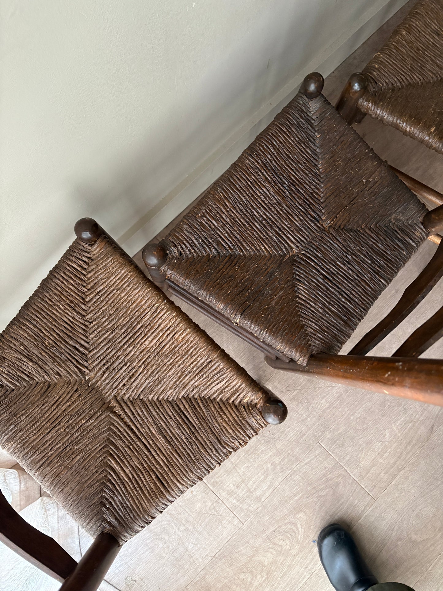 Stained oak rush seat ladder back dining chairs. Sold in pairs.