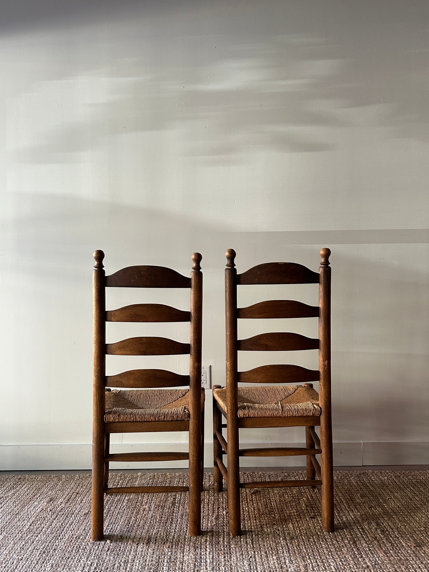 Pair of farmhouse ladder back chairs. Sold as a pair.