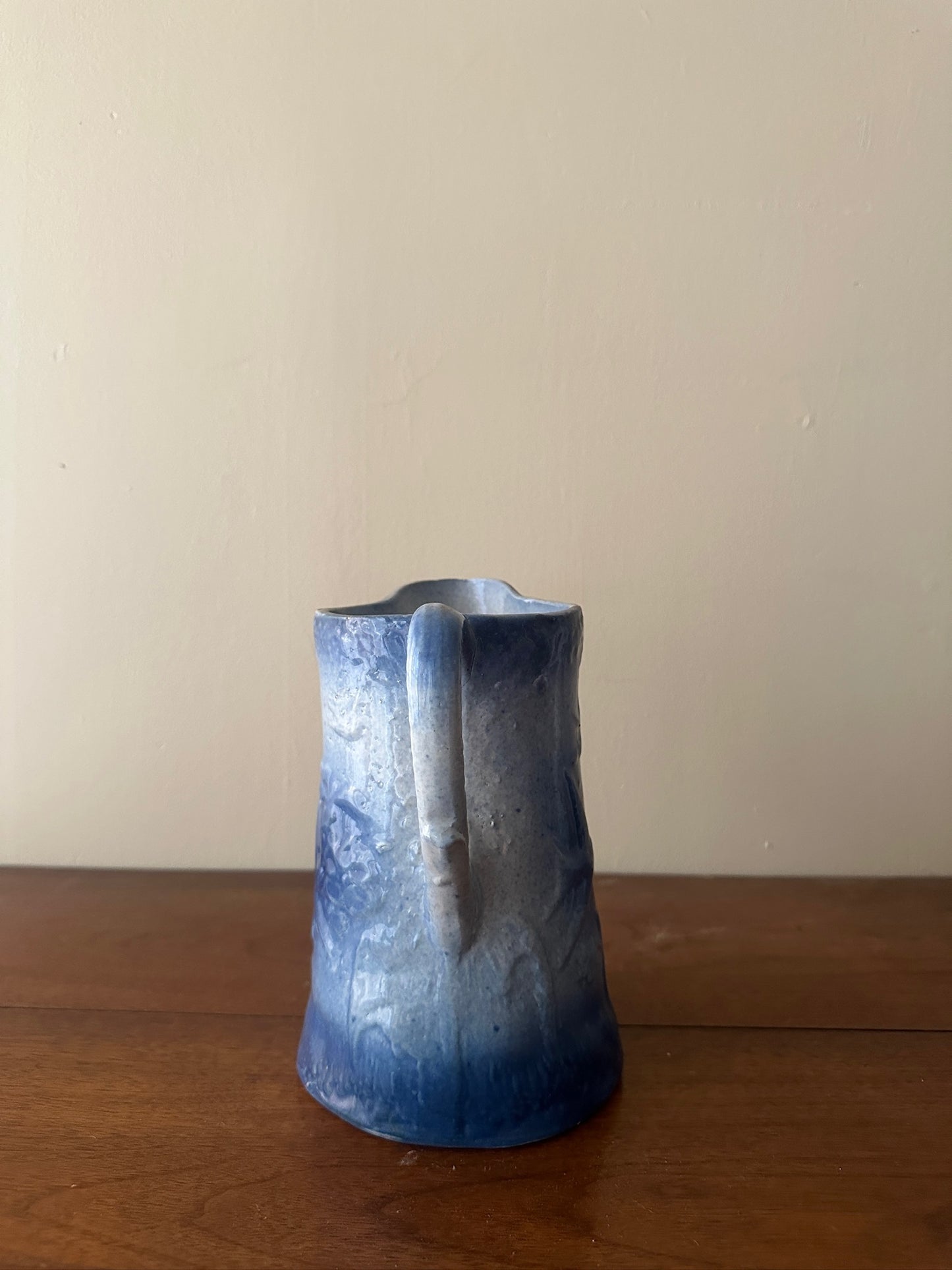 Salt glazed stoneware pitcher with birds and flowers