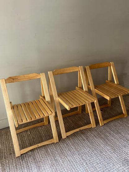 Oak folding chairs. Sold individually.