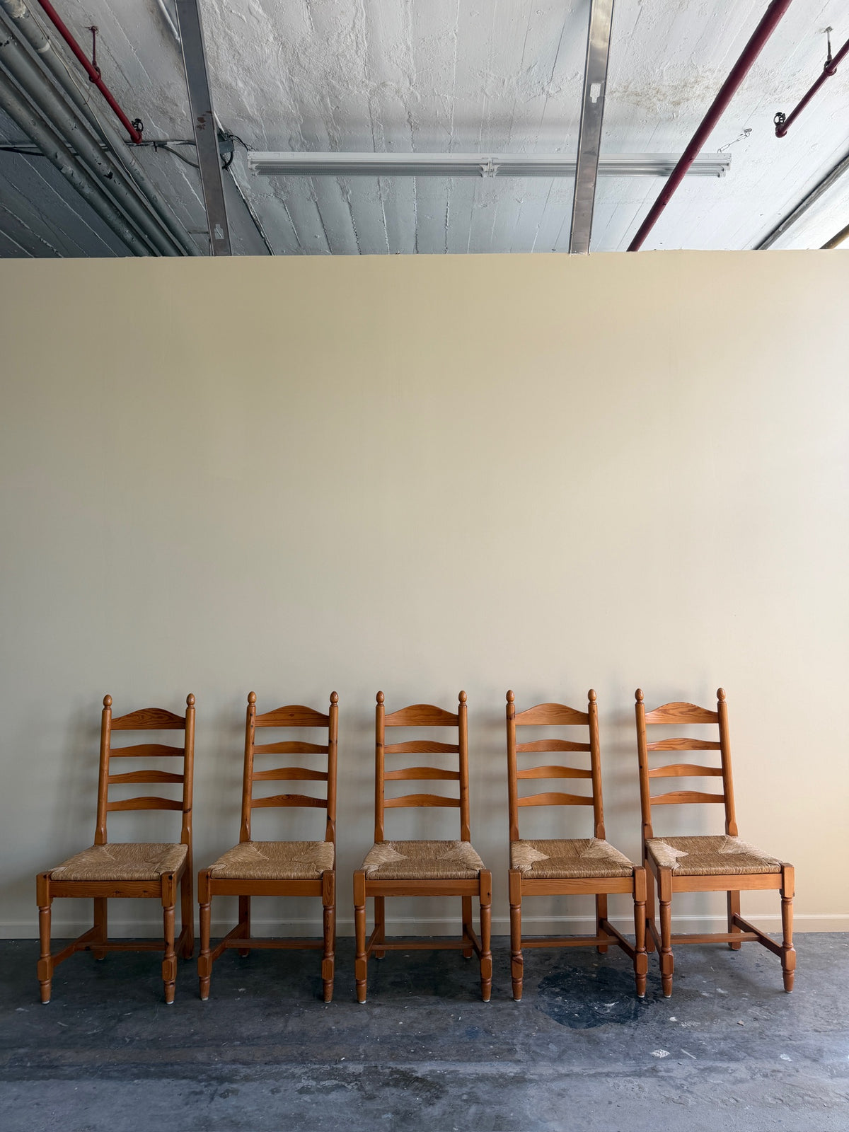 Dutch pine rush seat ladderback dining chairs. Sold individually.