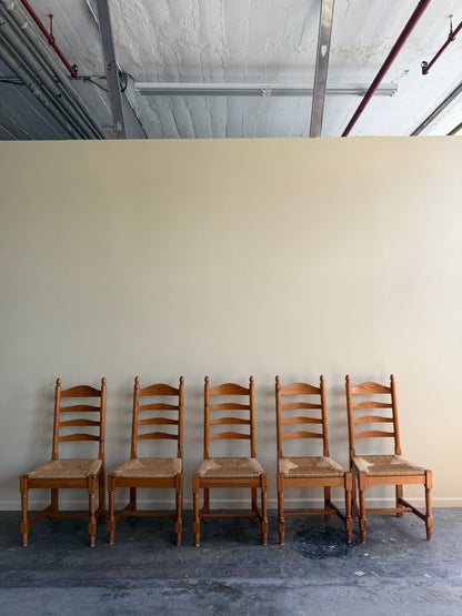 Dutch pine rush seat ladderback dining chairs. Sold individually.