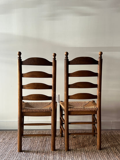 Pair of farmhouse ladder back chairs. Sold as a pair.