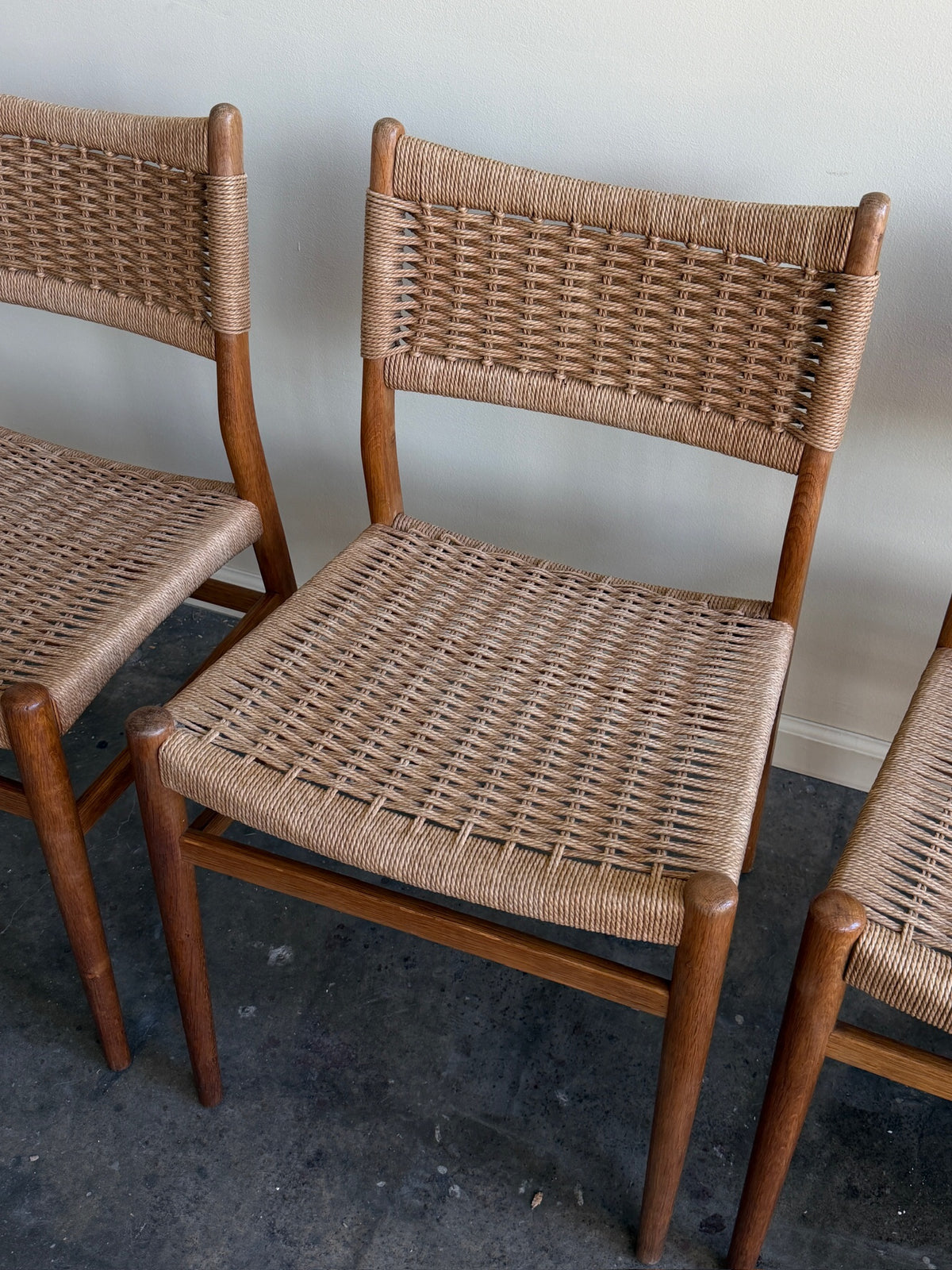 Danish oak and papercord chairs. Sold individually.
