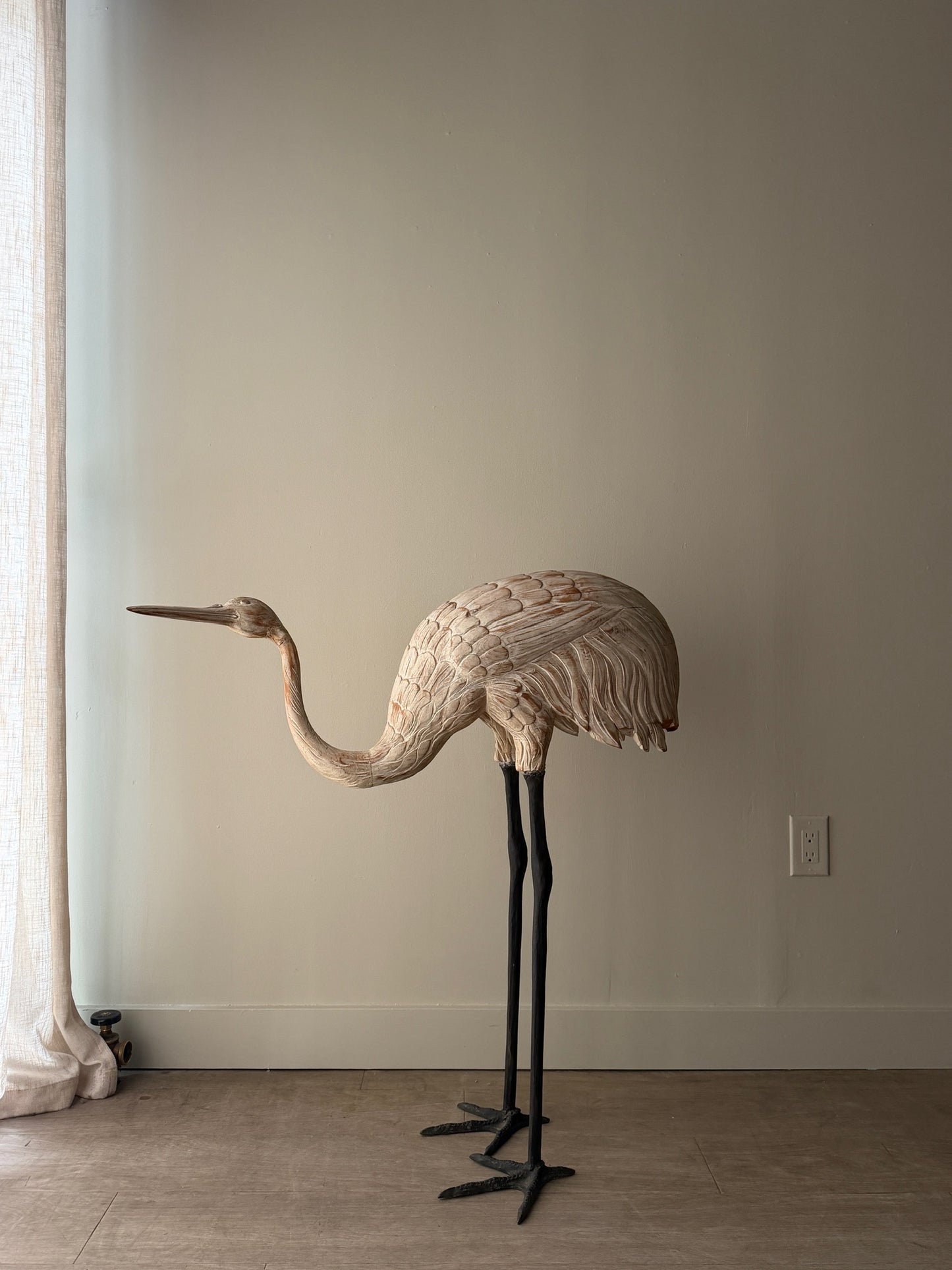 Wooden carved egret statue with iron legs