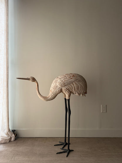 Wooden carved egret statue with iron legs