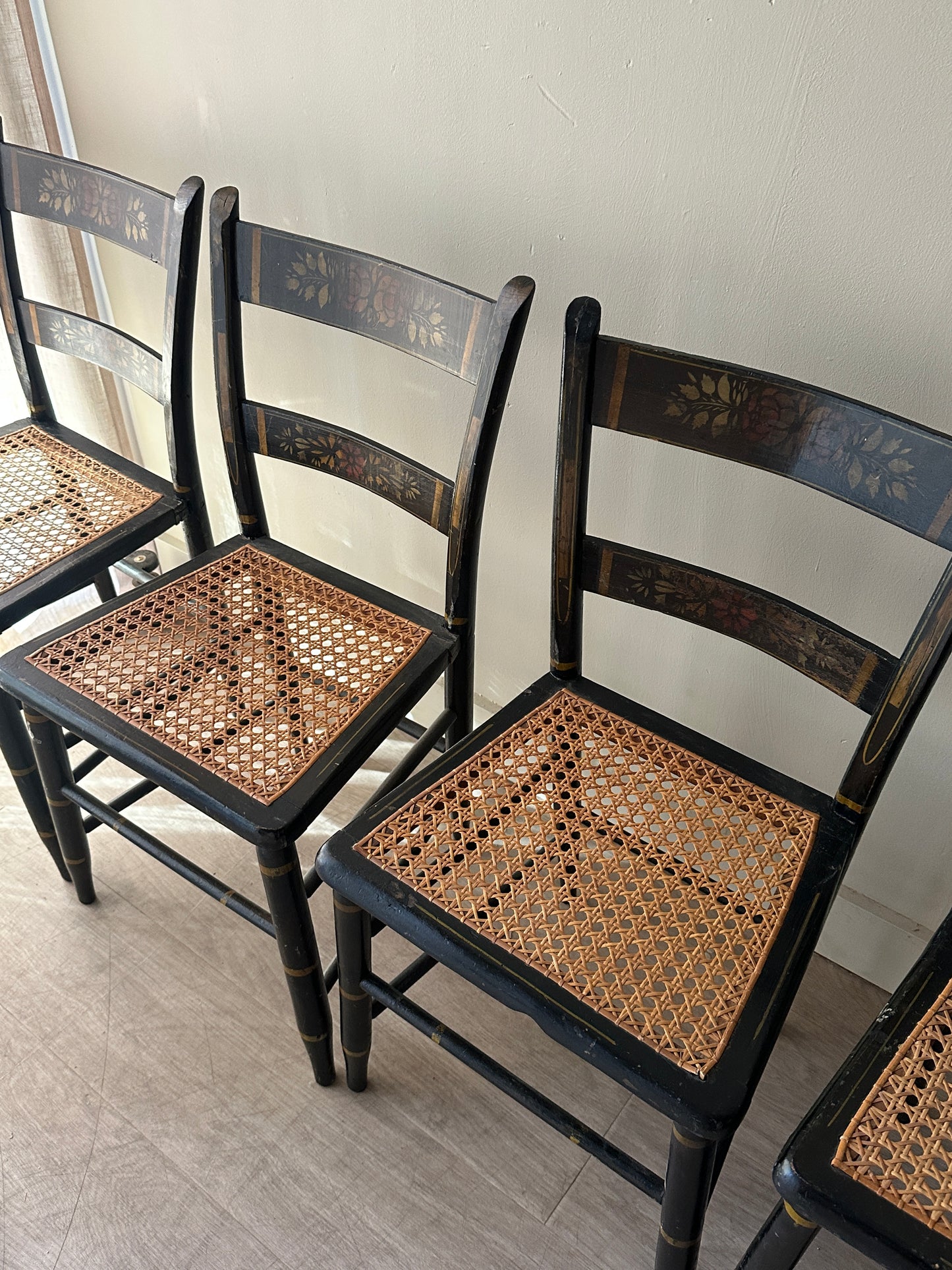 6 cane and black painted dining chairs. Sets of 2.