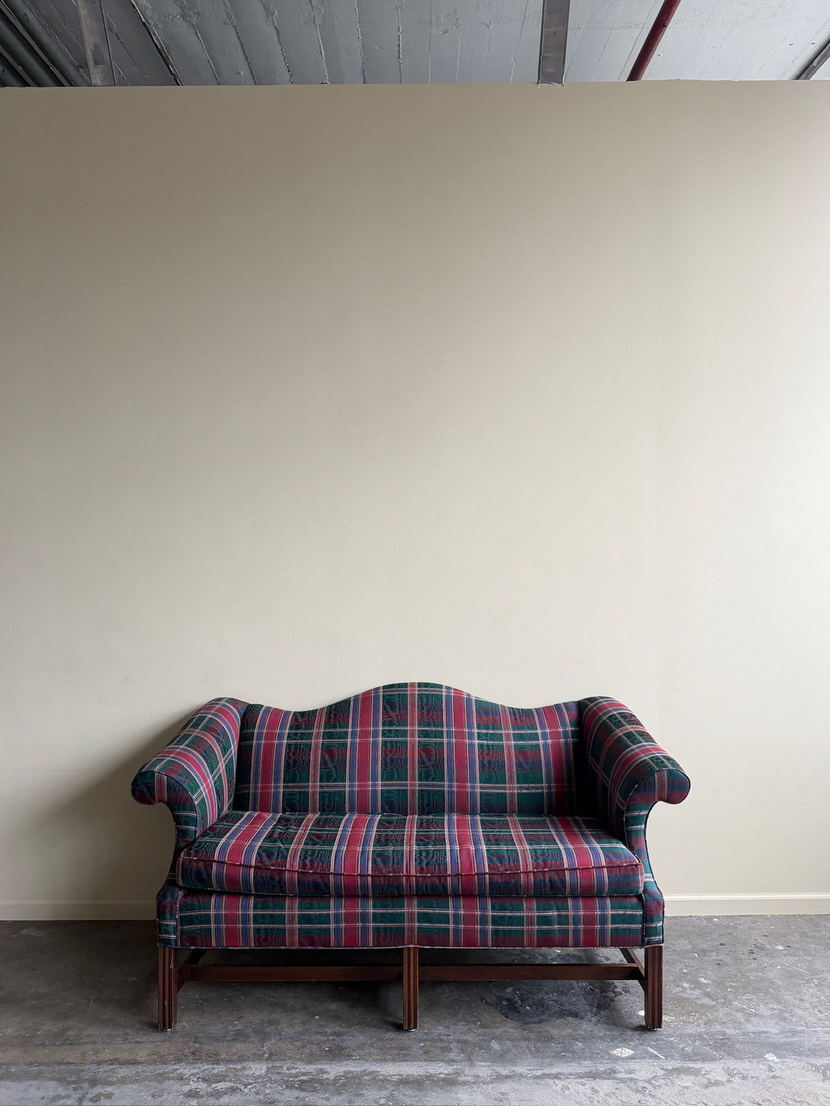 Camelback loveseat in plaid moiré upholstery