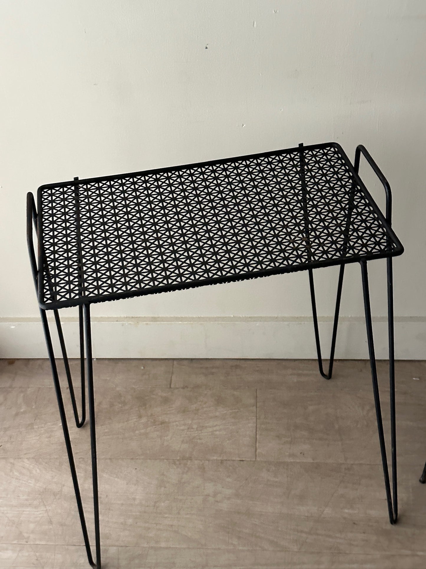 Black metal mesh side table (left)