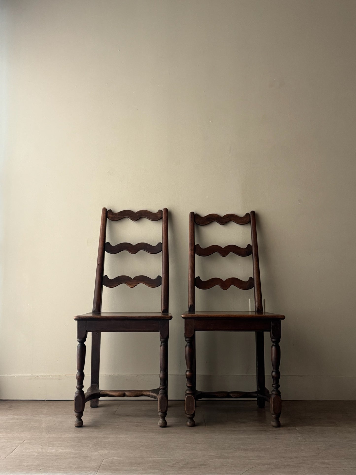 French oak ladder back dining chairs. Sold as a pair.