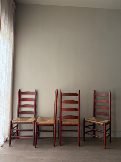 Stained oak rush seat ladder back dining chairs. Sold as a set of 4.