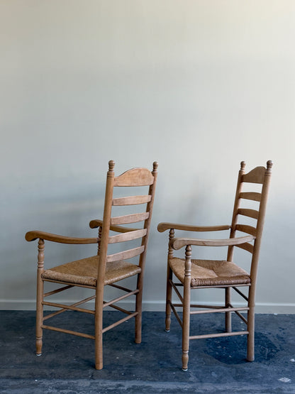 Beech ladder back rush seat arm chairs. Sold individually.