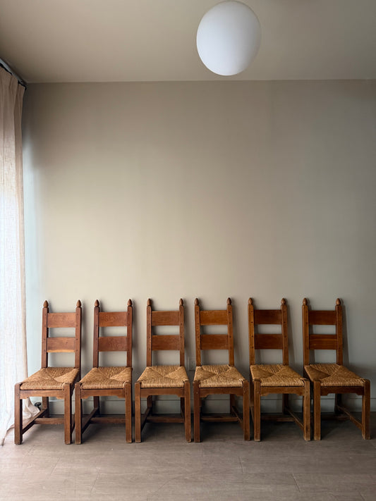 Dutch Brutalist oak rush seat dining chairs. Sold in pairs.
