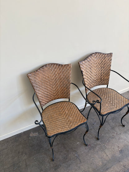 Wrought iron armchairs with woven bamboo backs & seats. Sold individually.