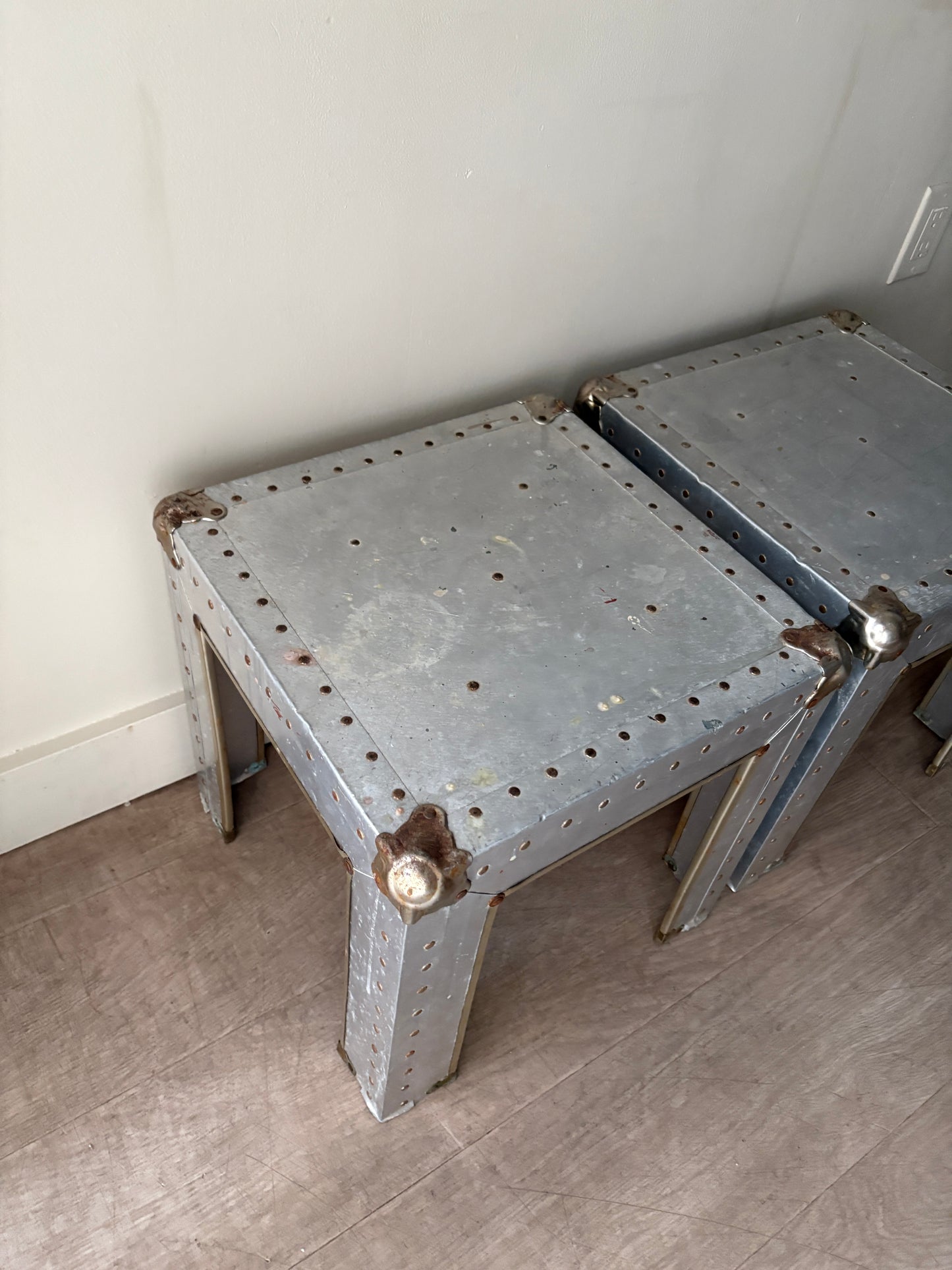 Riveted metal cocktail tables. Sold individually.
