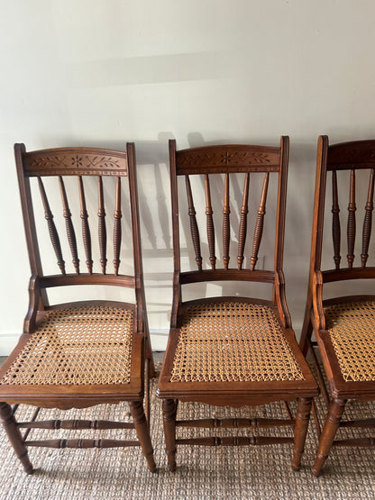 Carved cane chairs. Sold individually.