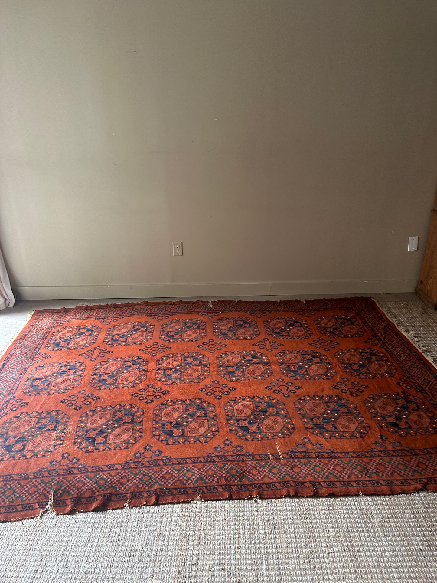 Low pile, rust colored rug