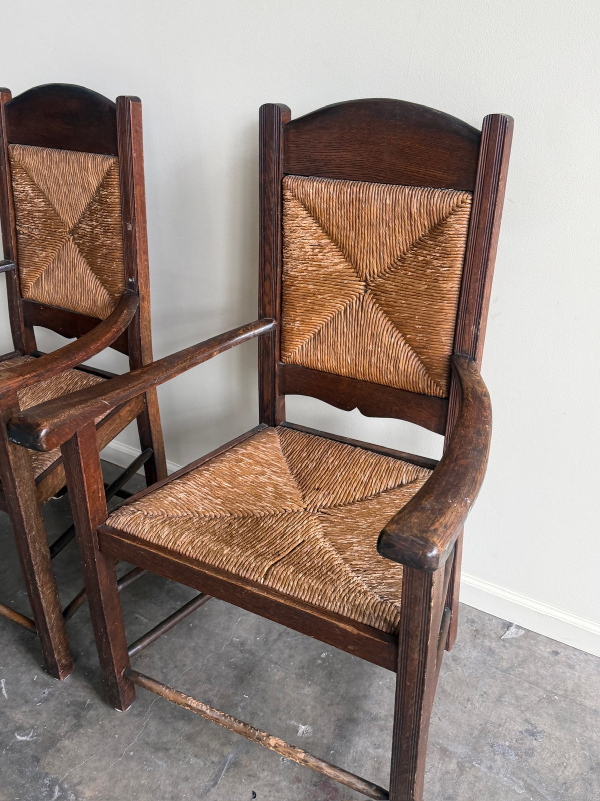 English provincial oak & rush armchairs. Sold individually.