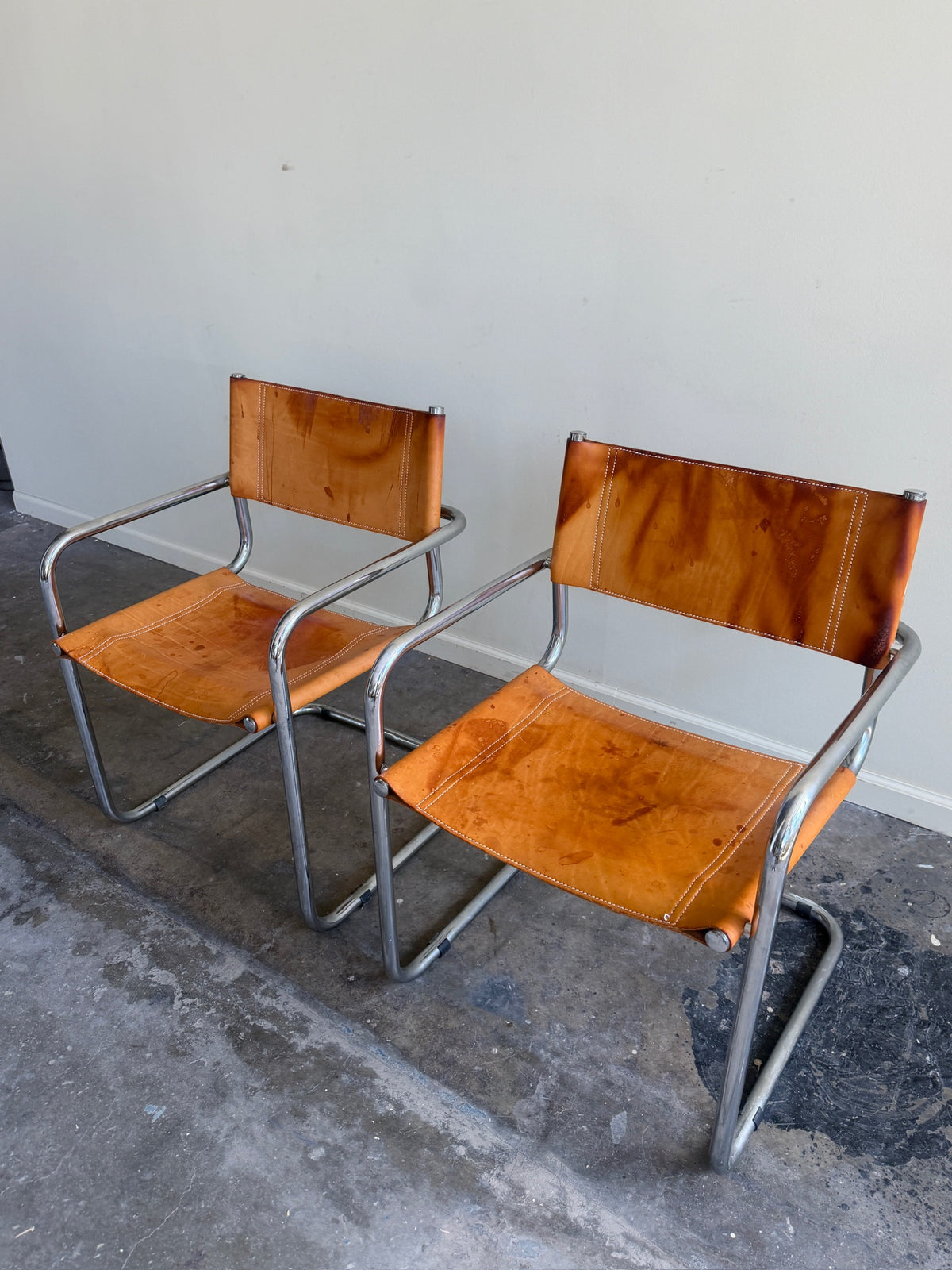 Chrome & leather armchairs. Sold individually.