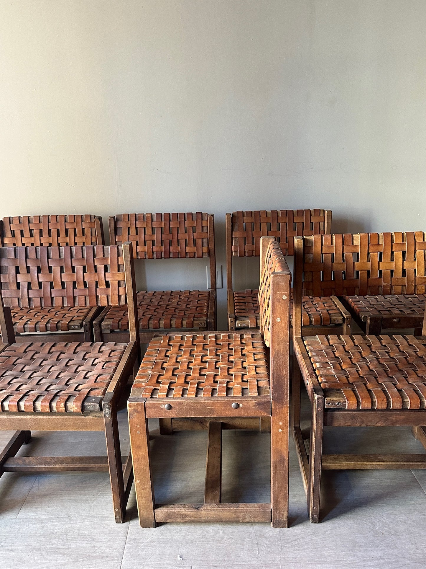 10 Jens Risom style woven leather dining chairs. Sold individually.