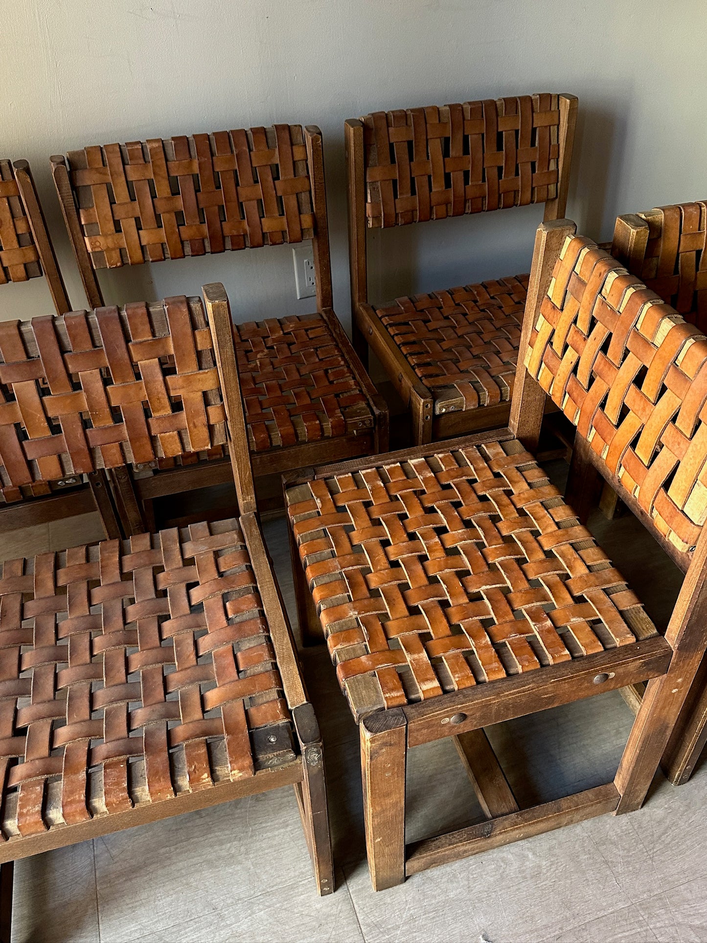 10 Jens Risom style woven leather dining chairs. Sold individually.