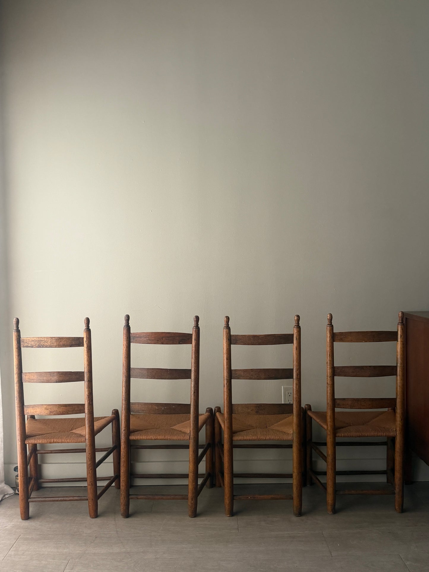 Pine ladder back rush seat chairs. Sold as a set of 4.