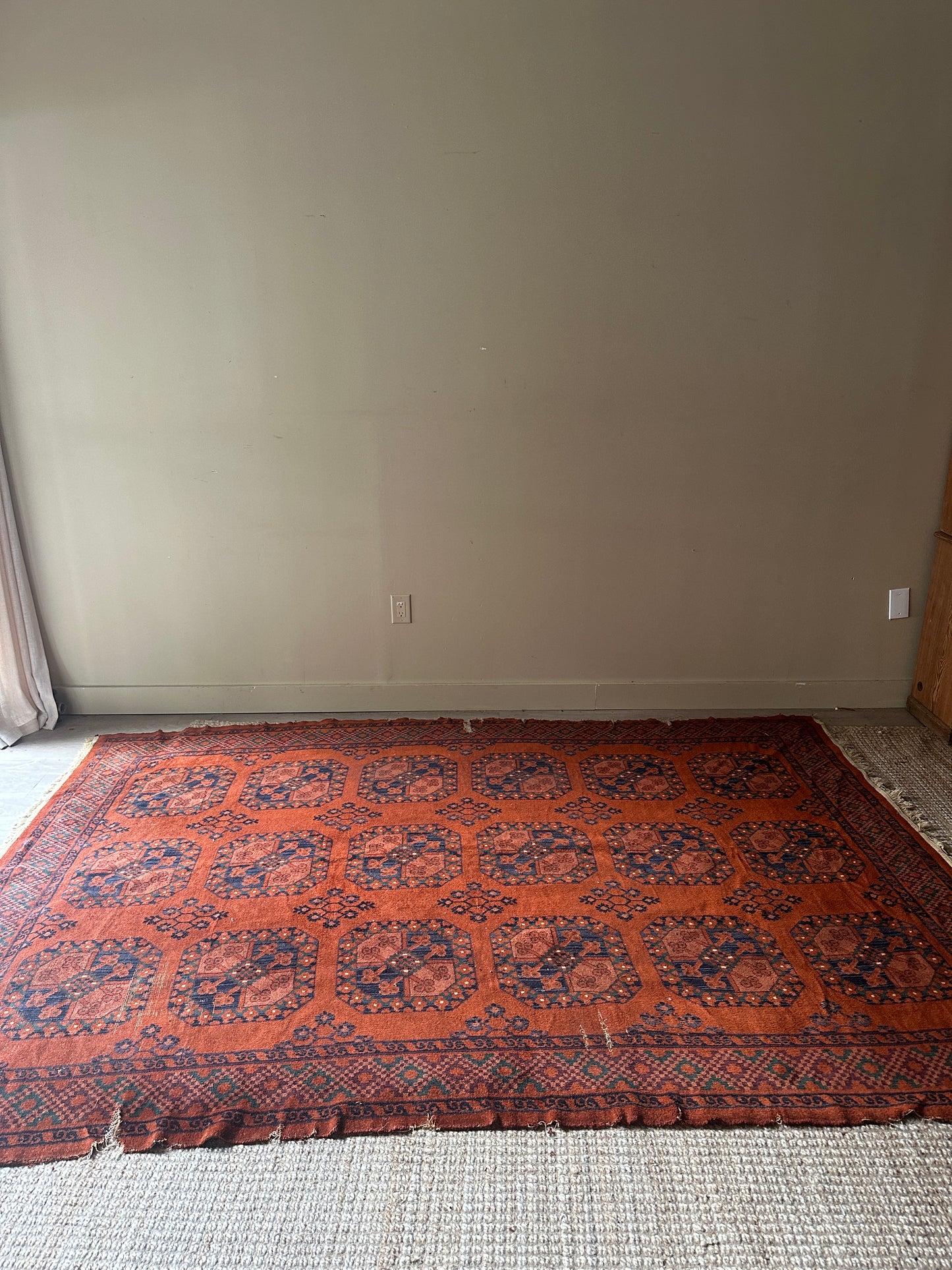 Low pile, rust colored rug