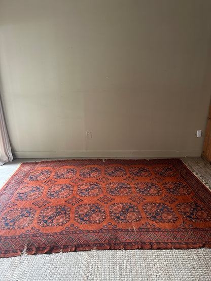 Low pile, rust colored rug