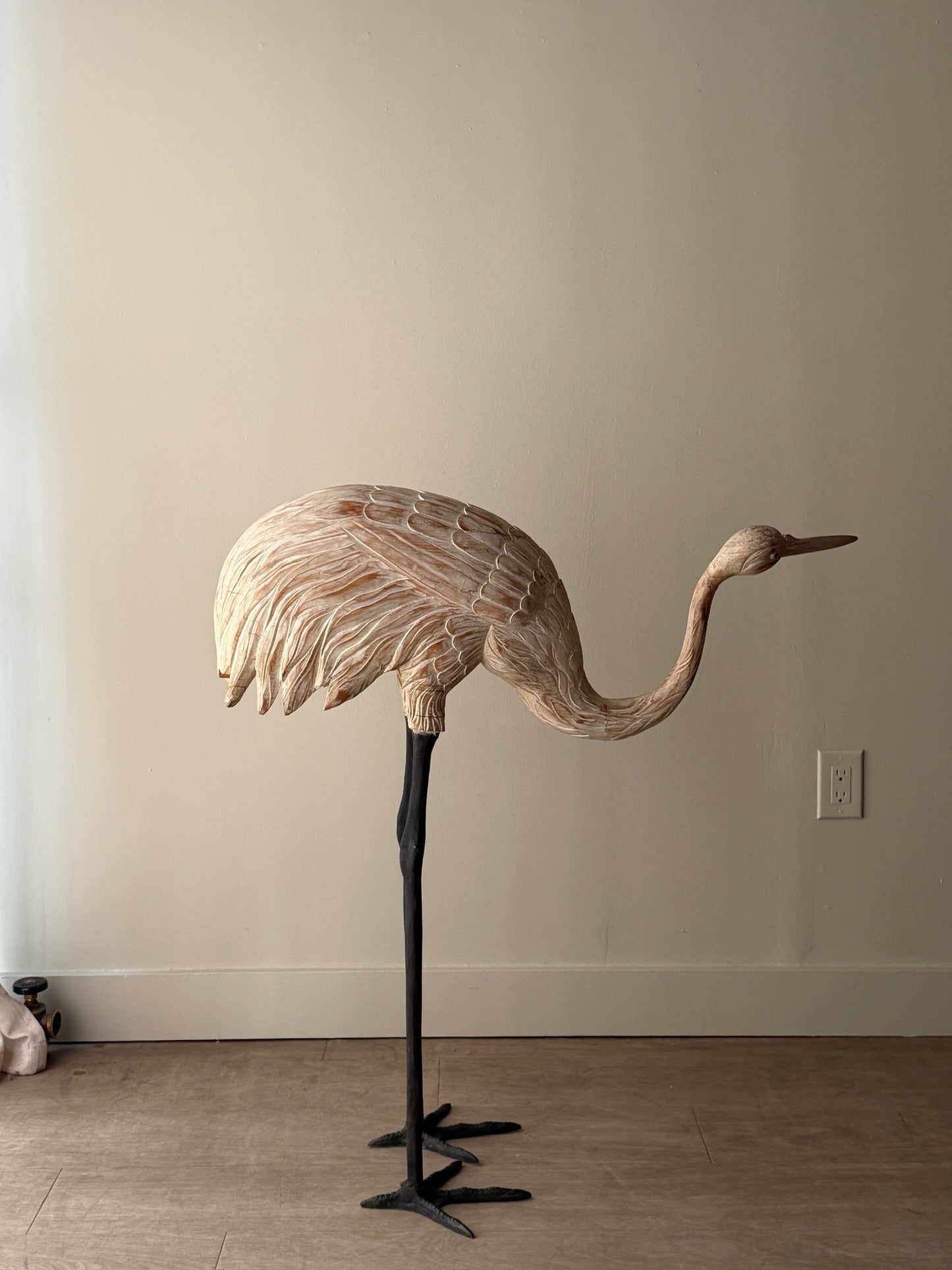 Wooden carved egret statue with iron legs