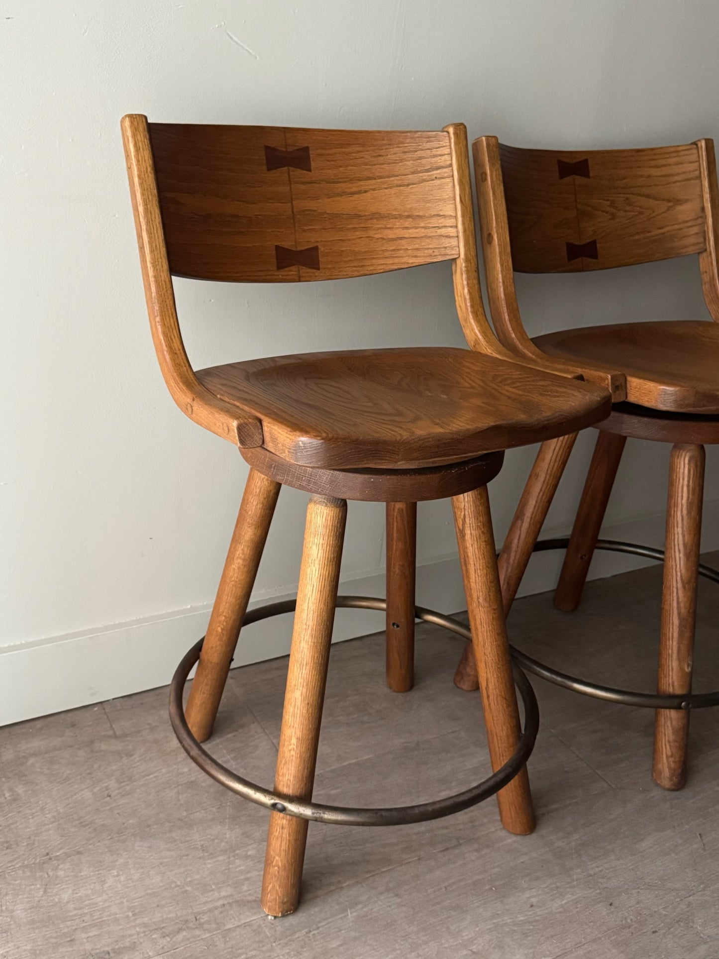 Conant Ball oak swivel bar stools. Sold as a pair.