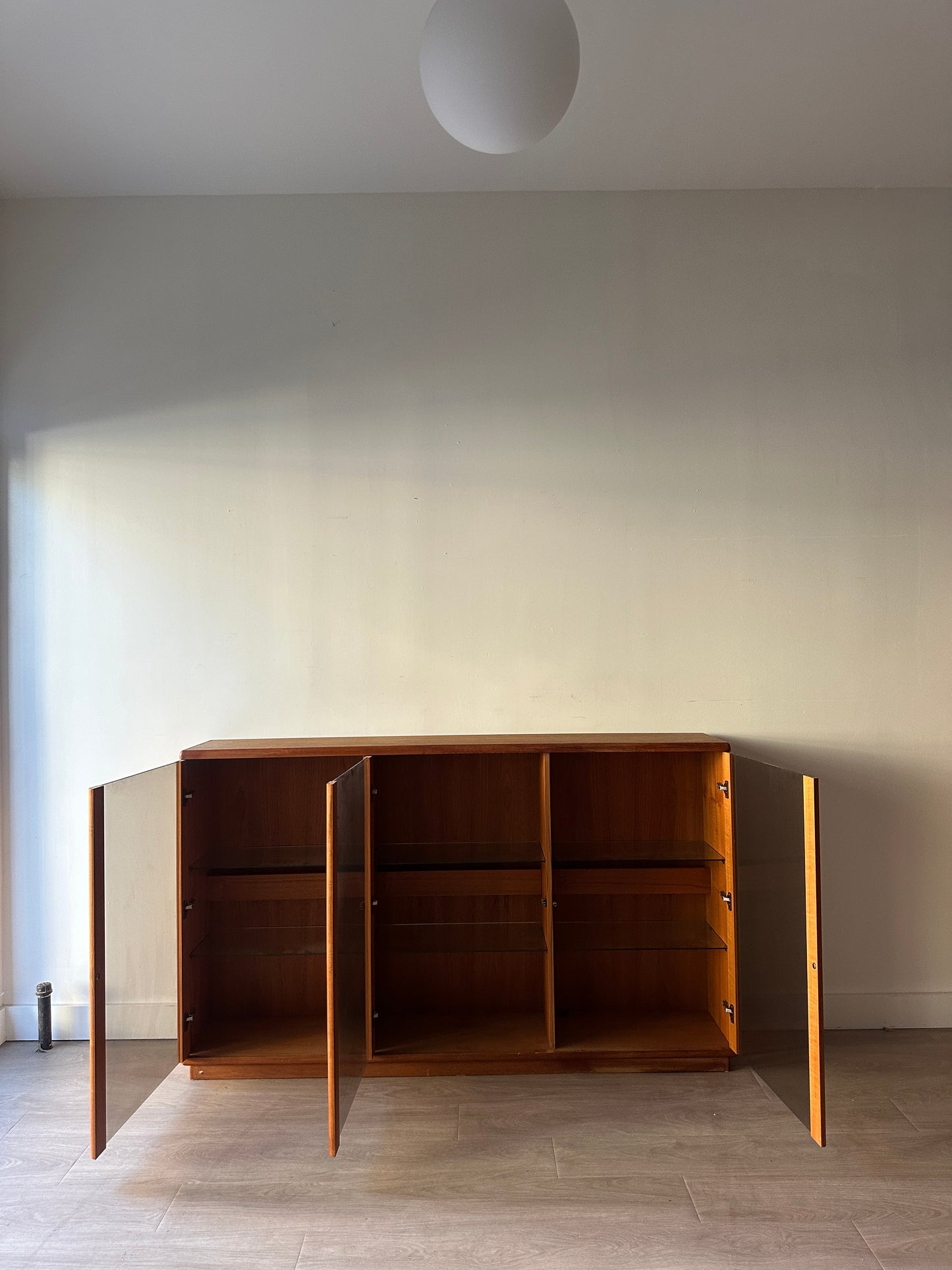 Smoked glass and teak bookcase